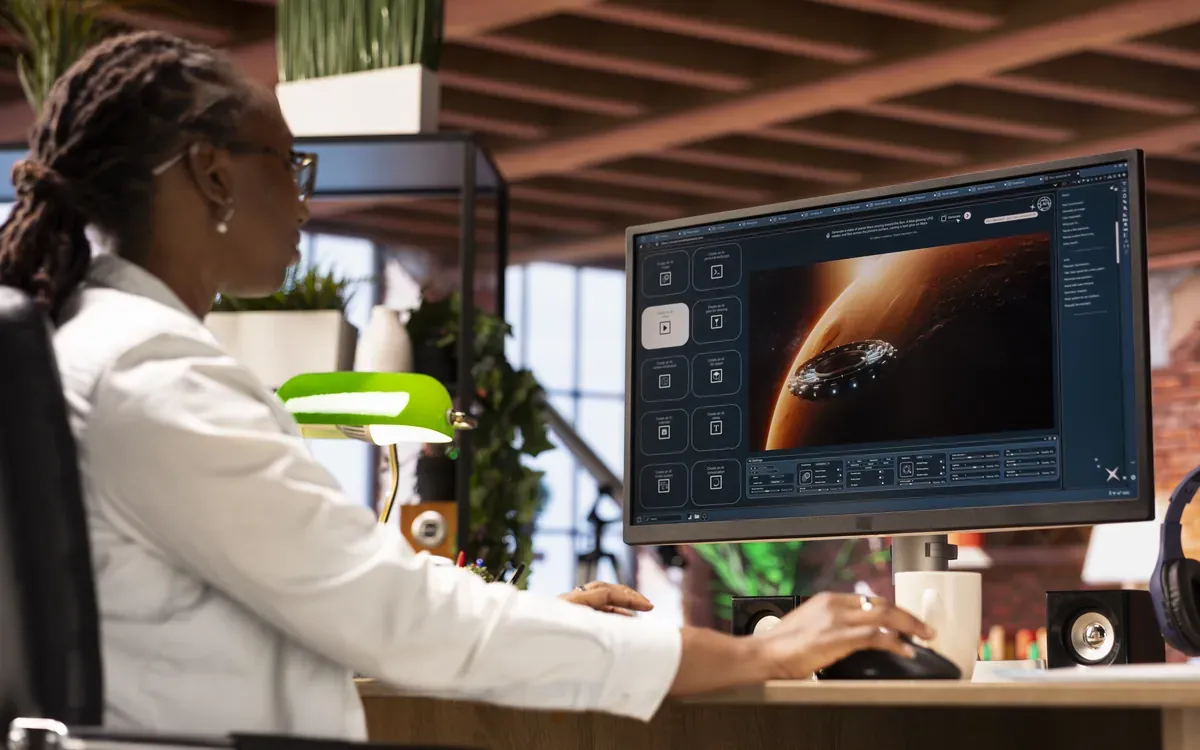 Créatrice noire générant une vidéo avec un outil d'intelligence artificielle sur un grand écran