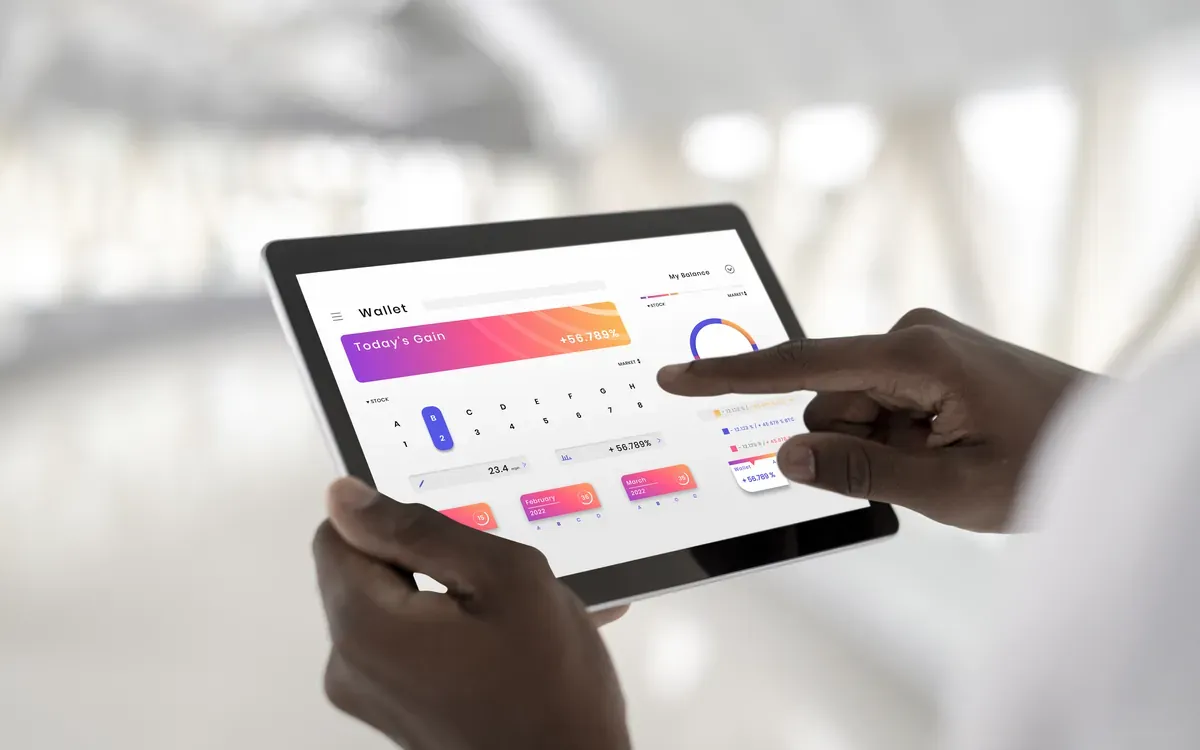 Mains noires consultant un tableau de bord de performances sur une tablette